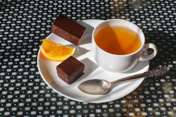 Cup of tea with Wafers in chocolate with biscuits and orange.