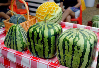 Cubic, square, triangular watermelons and watermelons with carving. Fresh ripe watermelons on...