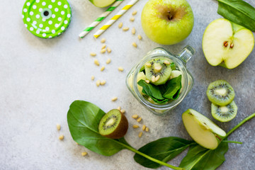 Ingredients for the preparation of green smoothies - apple, kiwi, spinach, pine nuts. Proper...