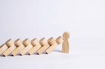 Man stops falling dominoes. Dominoes of people fall on one strong person. The concept of a bold, strong and decisive person. Strong business. Place for text.
