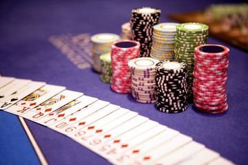 Casino chips and cards lying on table