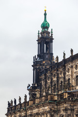 Fototapeta na wymiar Old City, Dresden. An ancient clock tower of the Royal Palace. Ancient architecture of Germany