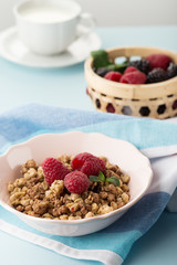 Classic breakfast with muesli and raspberries 