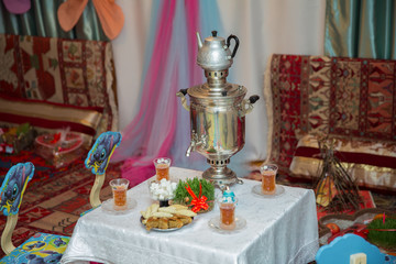 Novruz holiday background . Semeni on vintage plate decorated . Samovar and teapot . Samovar on a background of Novruz holiday . Tea in the tablecloth cups
