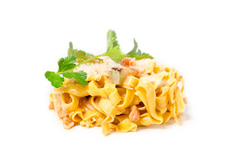 Pasta with pesto sauce, fresh basil and nuts on white plate