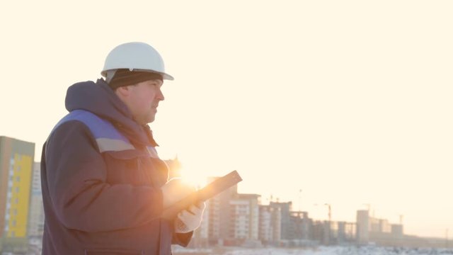 Foreman with tablet at major construction project