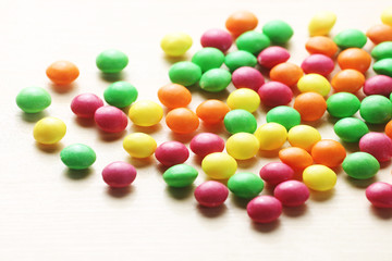 Colorful sweet candies on a wood background