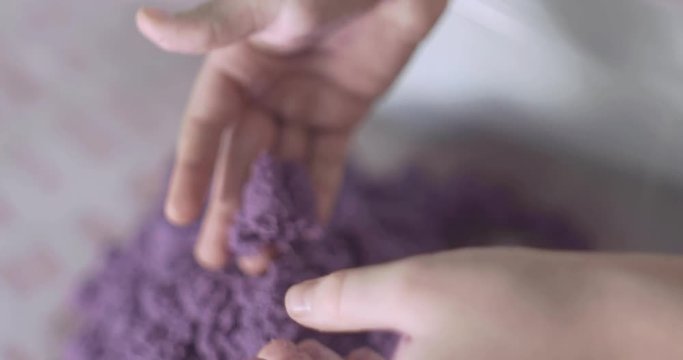 little girl plays with kinetic sand
