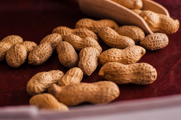 Peanuts in nutshell on a piece of wood