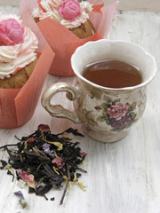 Afternoon tea with flowers cupcakes and brew on shabby table pastel colors
