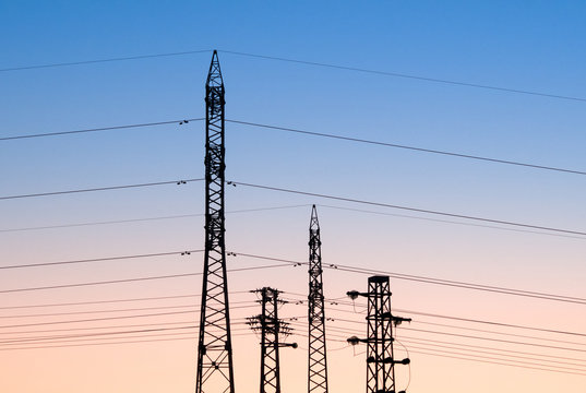Power poles and power lines at sunset