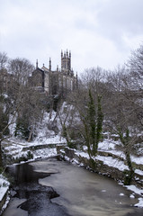 River Flowing Past Church in Winter