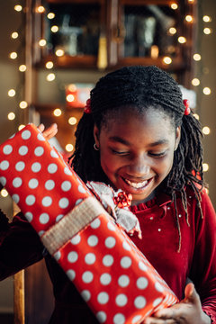 Happy African American girl receiving a Christmas present