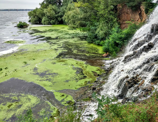 Waterfall flows into the river green water