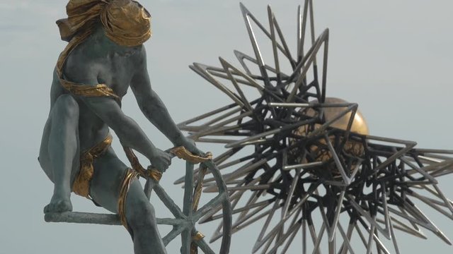 The Ulysses' statue and a spinning sun sculpture