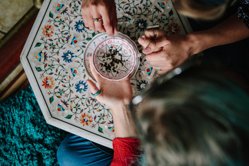 Tea leaf consultation, a fortune teller reading tea leaves