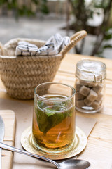 Mint Tea in a Glass with Sugar Cubes Behind