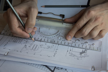 Architect's desktop. Plan of house. Architect workplace. Architect is working with drawings. Office work. Engineer calculates area of the room.