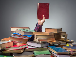 Man with book found among pile of books