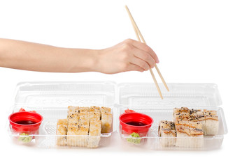 Set of rolls chopsticks for sushi in hand ginger wasabi soy sauce