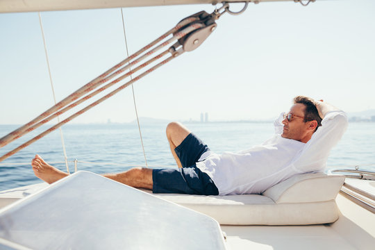 Man relaxing on sailboat.