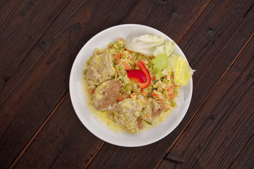 Stewed vegetables with oatmeal dumplings on a table