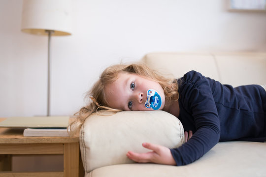 Young tired girl in the sofa