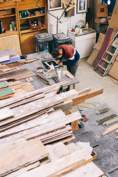 Overhead Shot of Young Carpenter at Work in Bright Workshop