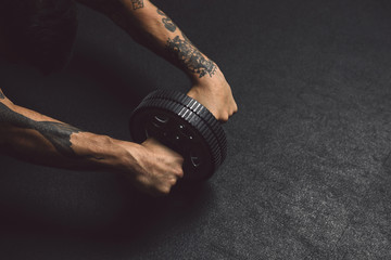 Men working out with ab roller