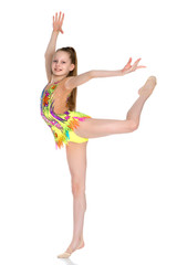 Fototapeta premium The gymnast balances on one leg.