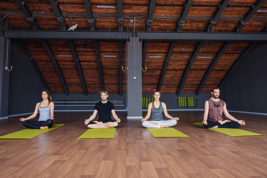 Group of people practicing yoga in yoga studio
