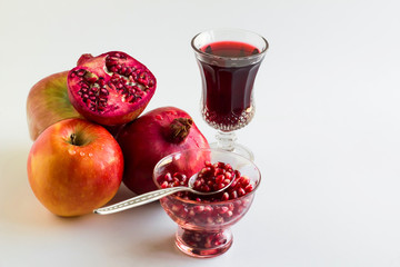 Rosh Hashanah,Traditional Jewish New Year concept.Symbolic foods are honey,apple,pomegranete and juices.Close up taken,isolated.