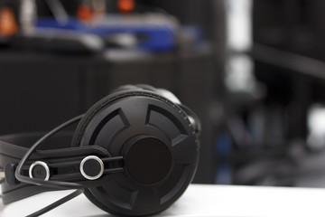 Studio headphones on the background of audio equipment