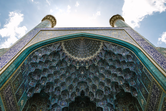 beautiful decorated and oriental arch of the entrance gate to shah mosque on imam square, esfahan, iran