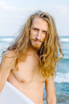 Male surfer looking at camera