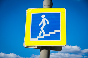 sign of a pedestrian crossing and blue sky