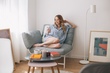 Woman browsing on her mobile phone indoor