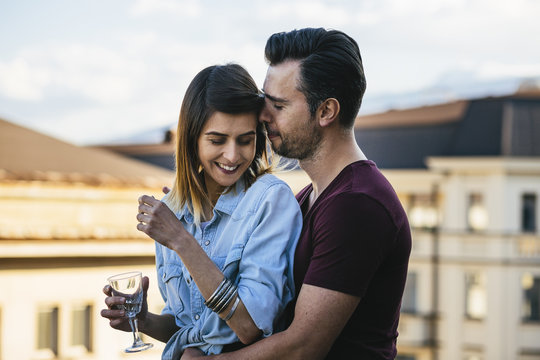 Young couple at the terrace by sunset