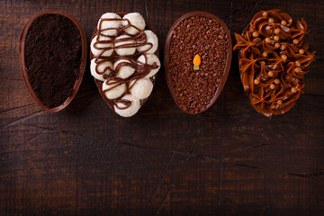 Chocolate egg with filling for Easter on wooden background