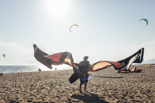 Man Holding Kite on the Beach