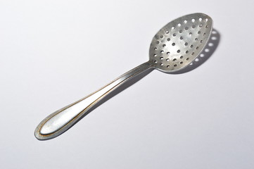 A special spoon with holes for removing foam while preparing soups.