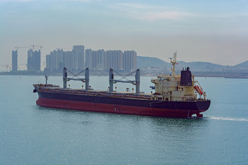Bulk carrier vessel leaves port.