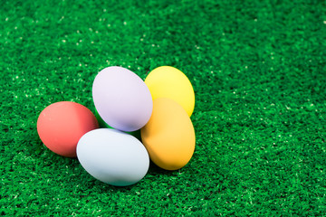 Eggs Easter pile on green grass for Happy Easter concept.