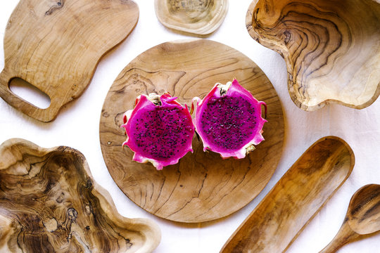 Delicious pink pitaya on wooden plate