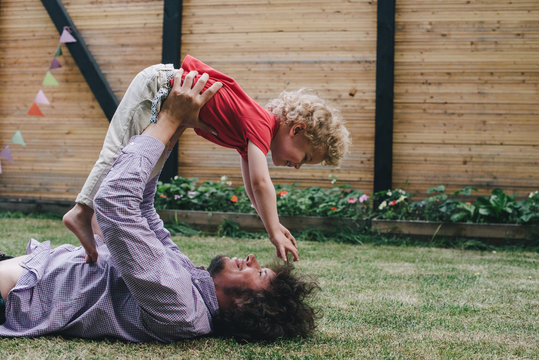 Father and son playing on the lawn