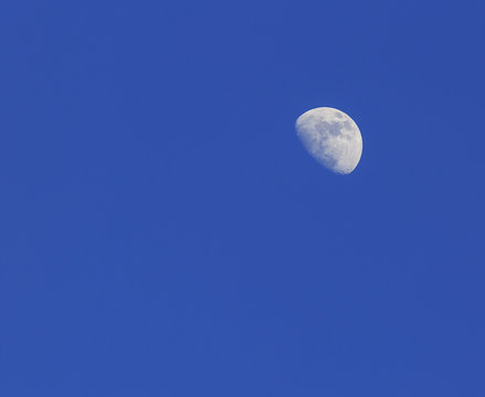A Crescent moon against a blue sky