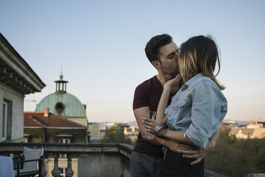 Young couple kissing at the terrace