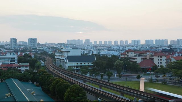 Closeup time lapse movie of clouds and sun rising in sky over Eunos housing estate with public MRT mass rapid transportation and auto traffic in Singapore early morning 4k UHD