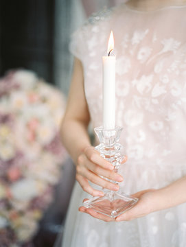 Woman holding a candel holder
