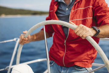 Skipper Navigating Sailboat